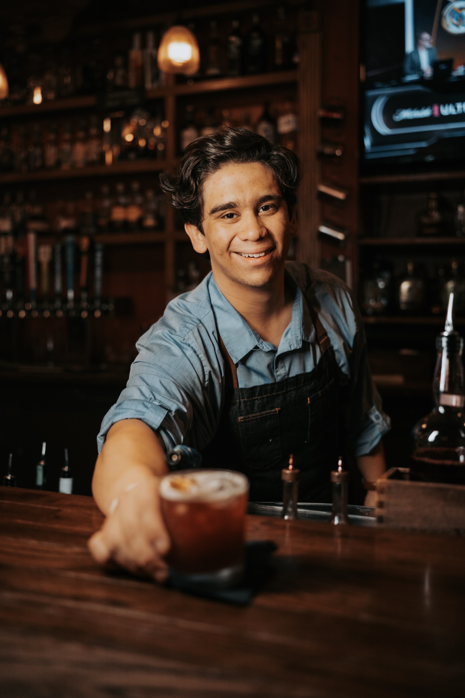 Barnett's bartender preparing a whiskey pour